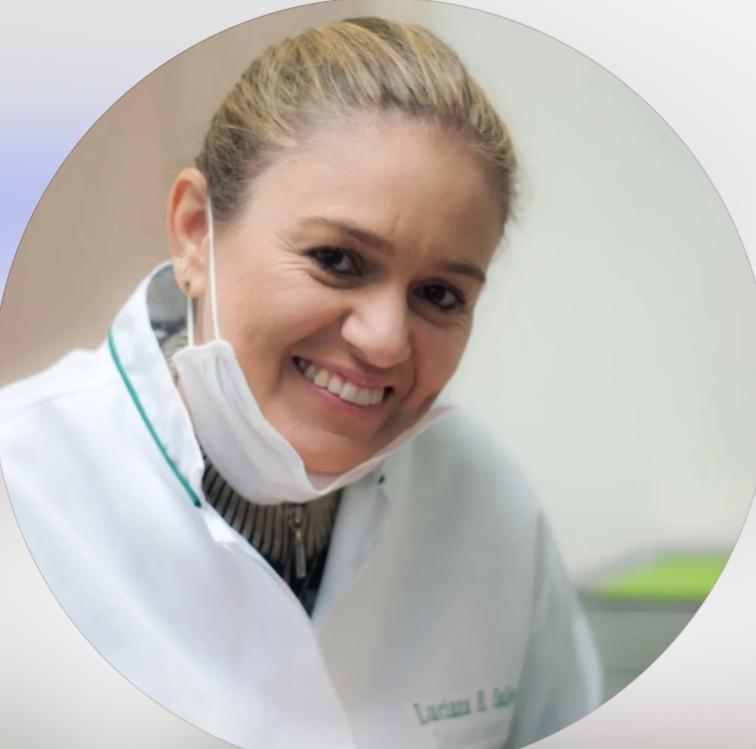 Dra. Luciana Salles sorrindo em seu consultório